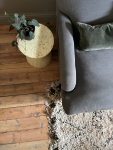 Grey linen sofa with berber rug